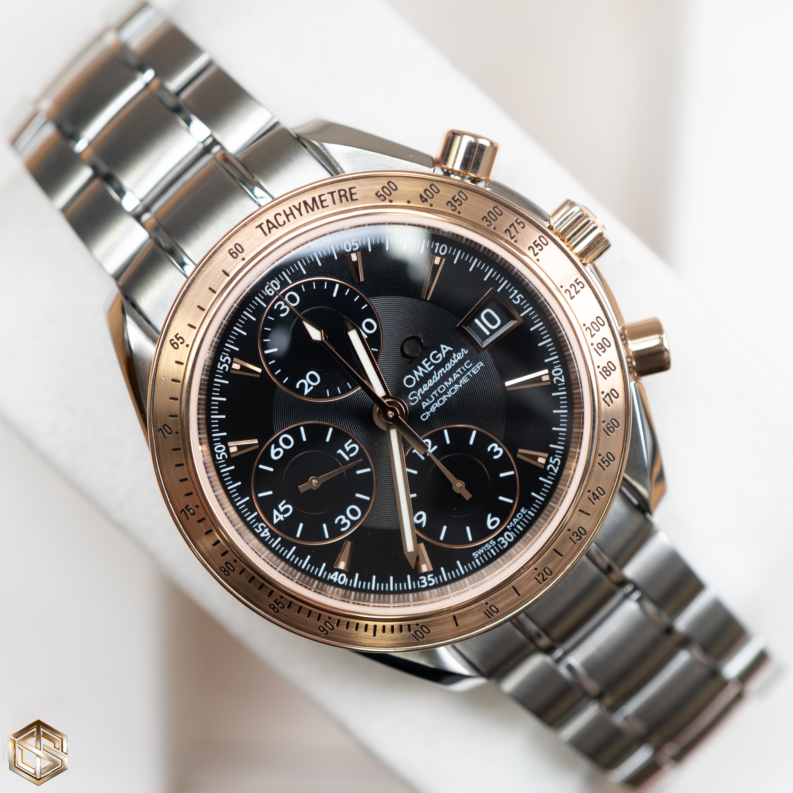 Omega speedmaster gold bezel deals